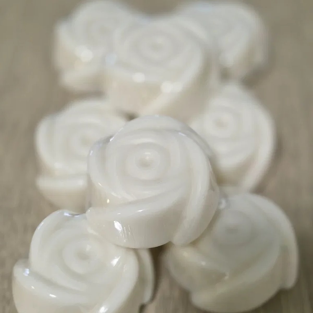 Rejuvenating Rice Exfoliating Soap rose bars on wood